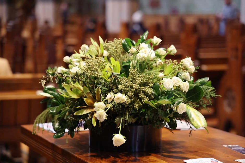 A lush white floral bouquet elegantly placed in a classic church setting, adding a serene touch.