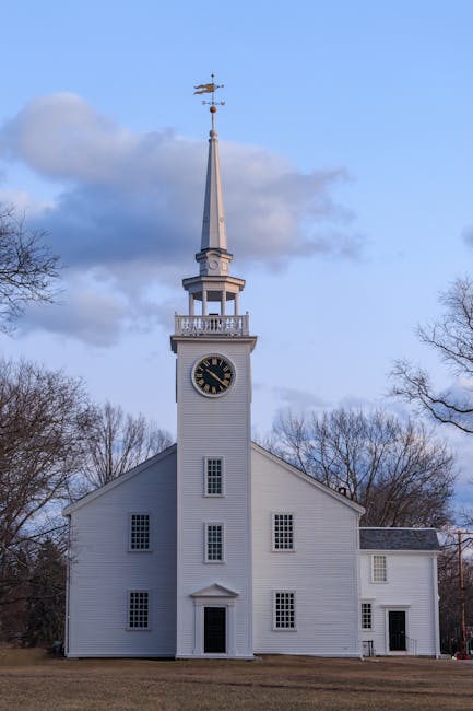 A beautiful white church with a tall steeple in Cohasset, Massachusetts during twilight.
